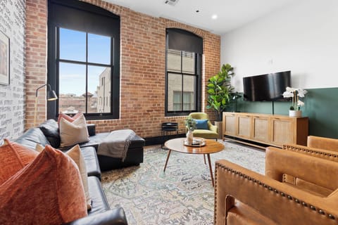 Relax in the living area with a smart TV, stylish seating, and a sleeper sofa for extra guests. Perfect for families or group stays in New Orleans, this inviting space is ideal for movie nights or recharging after a day in the city.
