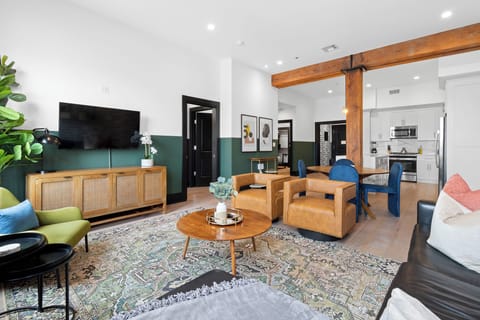 Relax in the living area with a smart TV, stylish seating, and a sleeper sofa for extra guests. Perfect for families or group stays in New Orleans, this inviting space is ideal for movie nights or recharging after a day in the city.