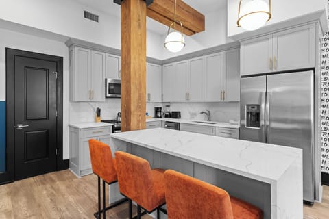 Cook or snack in style with a full kitchen featuring GE stainless appliances, cookware, and an island with bar seating. Ideal for short or extended stays, our kitchens make group travel in New Orleans easy and comfortable.