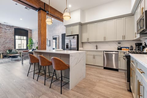 Cook or snack in style with a full kitchen featuring GE stainless appliances, cookware, and an island with bar seating. Ideal for short or extended stays, our kitchens make group travel in New Orleans easy and comfortable.