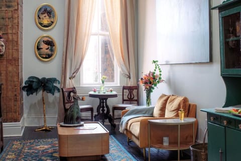 Antique and modern pieces blend with original fine art, creating a warm and comfortable living space. Not shown is the large tv, across from the sofa.