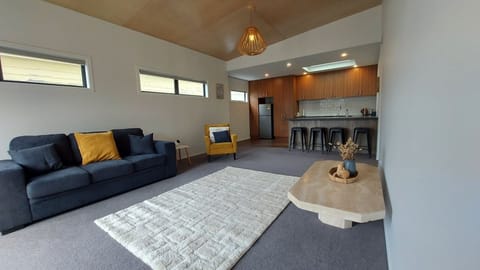 Living room with view to breakfast bar / kitchen. Couch folds out if needed.