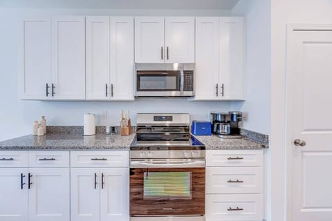 Enjoy a brand-new kitchen equipped with sleek stainless steel appliances, perfect for cooking and dining in style.