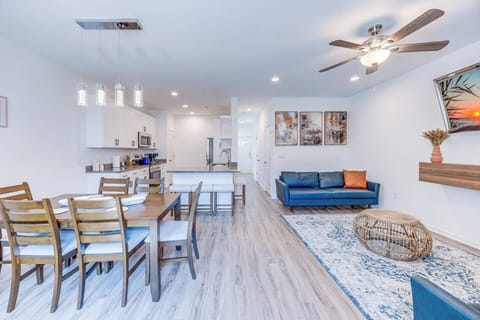 Gather around the dining table for six in this open-concept space that seamlessly flows into the living room and kitchen for a connected and inviting atmosphere.