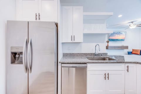 Cook in style in this brand-new kitchen featuring sleek stainless steel appliances and modern finishes.
