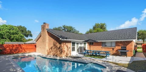 Gorgeous, shady backyard pool and patio provide a luxury Texan relaxation experience