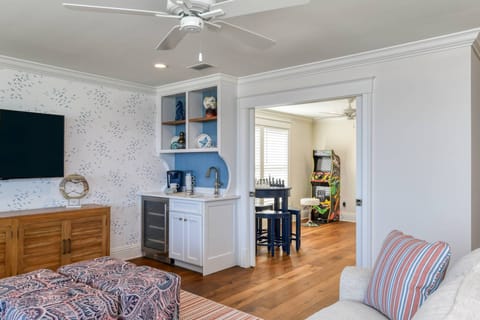 The second living room features a large tv and wet bar! Just through these double doors you'll find endless opportunities for fun in the arcade!