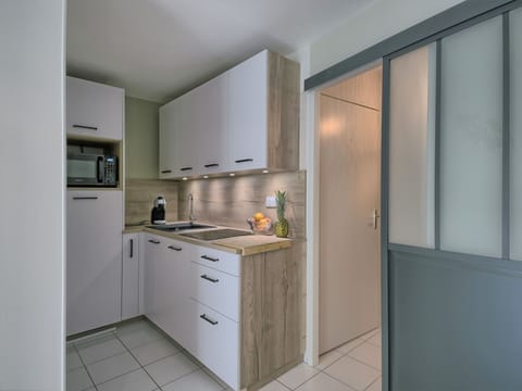 Building, Cabinetry, Countertop, Kitchen Stove, Kitchen, Wood, Kitchen Appliance, House, Flooring, Floor