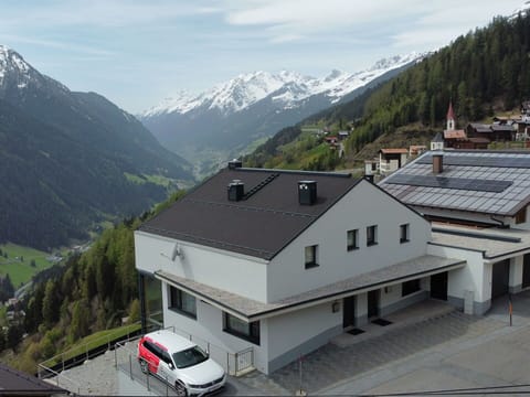 Mountain, Cloud, Sky, Building, Window, White, Vehicle, House, Slope