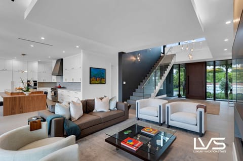 Living Room- Plush seating arrangements invite relaxation, while carefully curated decor and art pieces add a touch of luxury. The open-concept design seamlessly connects the living area with the dining space, creating an ideal setting for both intimate gatherings and grand entertaining.