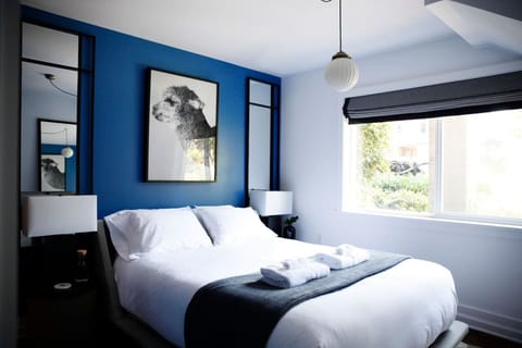 This bedroom features a soothing combination of blue and white walls, creating a fresh and inviting atmosphere for a restful retreat.