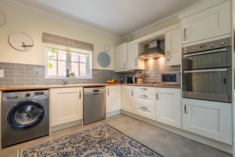 Ground floor:  Kitchen with double electric oven, gas hob, dishwasher, washing machine, microwave, full height fridge/freezer and Nespresso coffee machine