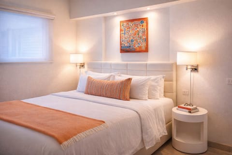 Unwind in crisp linens under warm, calming bedside glow.