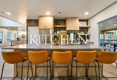 The kitchen features modern appliances, a breakfast bar, and everything you need to prepare delicious meals for the whole group.