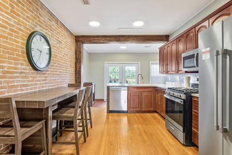 Cook and gather in our spacious kitchen, complete with an extra table for four.