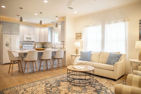 Open floorplan kitchen and living room with full-size sofa bed 