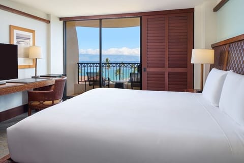 Stretch out in crisp linens with a balcony beyond.