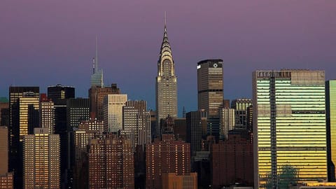 Watch the city glow as evening lights sparkle outside.