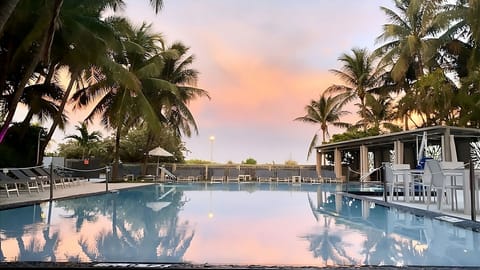 Sip and relax as sunset colors glow over the pool.