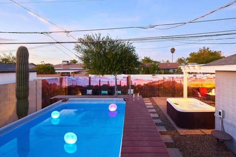 Private backyard patio with a new mural, outdoor dining area, ample seating, hot tub, above-ground pool, lounge chairs, fire pit, BBQ grill, ping pong table, and horseshoe.