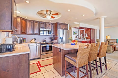 Counter seating faces kitchen.