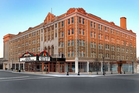 Arrive to a grand historic façade glowing at golden hour.