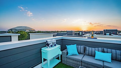 The rooftop deck boasts stunning stadium views and a cozy couch, perfect for relaxing and taking in the vibrant surroundings.