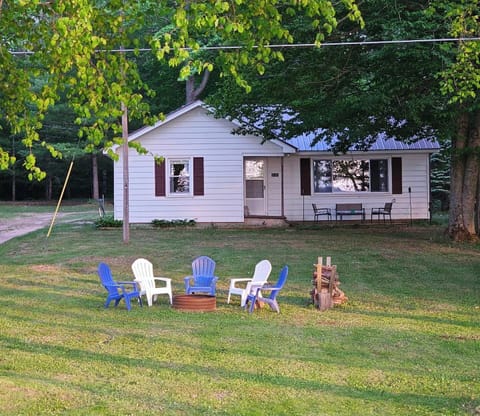 OVERALL:  The front of the cabin in summer with the private bonfire ring in the front yard.
