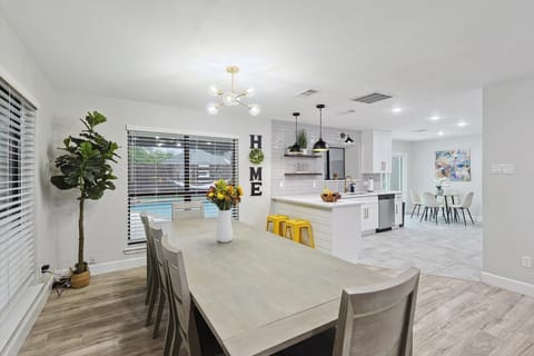 A bright and modern kitchen with sleek finishes, stylish pendant lighting, and a cozy breakfast bar. The open layout flows into the dining area, creating the perfect space for cooking, dining, and entertaining.