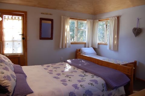 Bedroom showing both beds and door to balcony