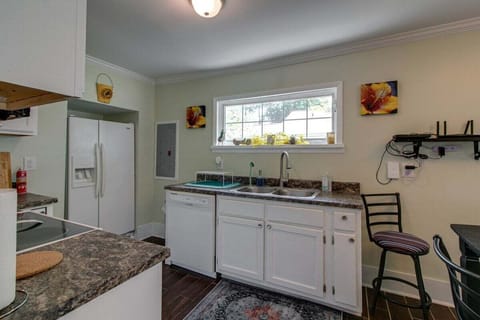 The kitchen is stocked with everything you need from plates, pans, pots, cups, coffee maker, and tea kettle!