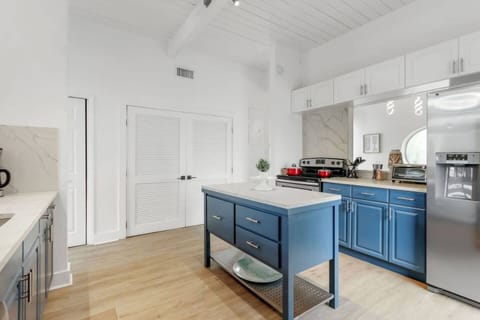 sleek stainless steel appliances and a spacious island, perfect for meal prep, dining, and entertaining in this modern kitchen.