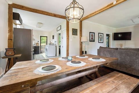 The dining area offers ample seating for six at the table, perfect for enjoying meals with family or friends. The open-concept design connects the living and dining spaces, creating a warm and inviting atmosphere for gathering and making memories.