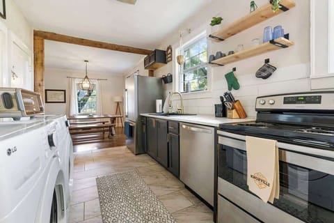 Enjoy a well-appointed kitchen featuring a double sink, dishwasher, refrigerator, stove, and microwave, perfect for preparing meals with ease. You'll also find a washer and dryer available for your use in this space. 