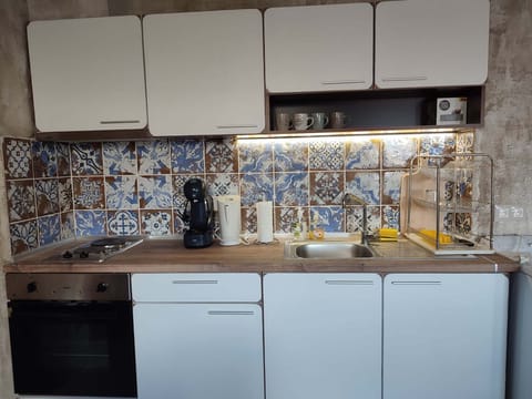 Kitchen corner with an oven, stove, coffee machine, led, dishes and utensils