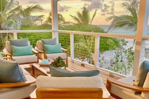Enjoy morning coffee in the cozy outdoor lounge area with plush teak furniture