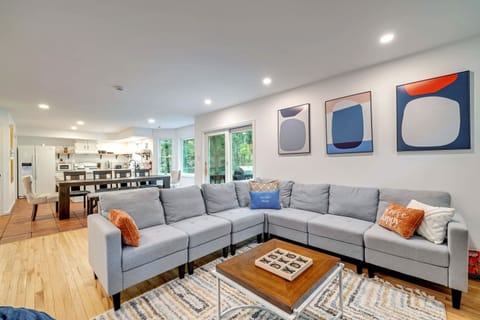 A sophisticated and stylish living room, perfect for entertaining or simply unwinding. The large windows offer stunning views, while the modern art adds a touch of elegance.