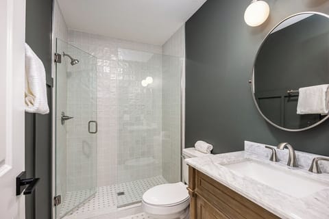 The full bathroom features a walk-in shower.
