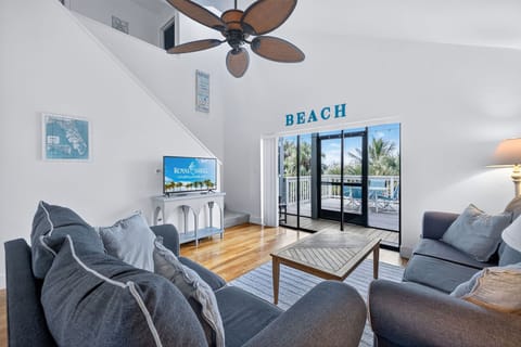 Bright, spacious living area with vaulted ceilings and slider access to private balcony