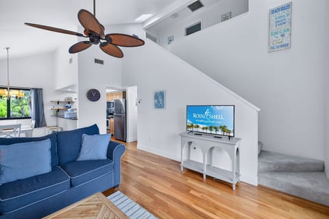 Bright, spacious living area with vaulted ceilings and slider access to private balcony