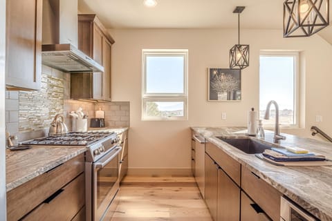 Beautiful and thoughtful finishes from the large sink, to the backsplash and granite countertops.