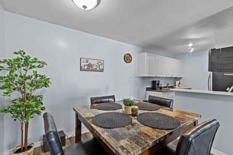 Dinning room with high top table and 4 chairs. With view to the kitchen.