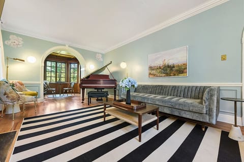 Elegant living room with baby grand piano and cozy seating