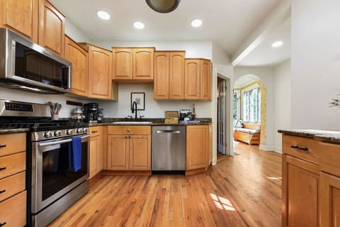 Fully stocked kitchen with stainless appliances and gas stove