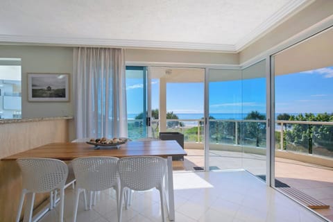 The open-plan dining area includes a six-seater setting that boasts stunning oceanfront views.
