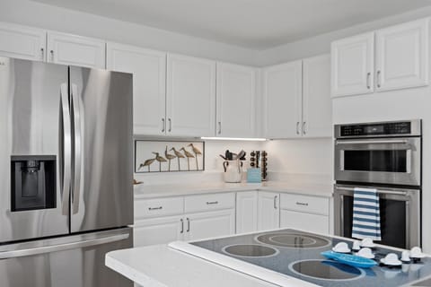 The seamless transition between the living room and kitchen ensures that entertaining becomes effortlessly enjoyable.