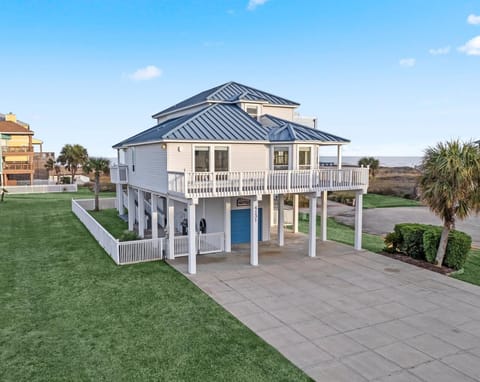 Quintessential beach house with a picturesque escape, capturing the essence of coastal charm from its pristine white picket fence and coastal blue tin roof to its soothing nautical interiors.