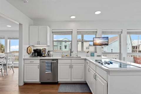 The fully equipped kitchen is adorned with stainless steel appliances and other comforts of home including a combo Keurig/Regular Coffee Maker with Keurig Pod Tower, Electric Hot Water Kettle, Instapot with Air Fryer, Blender, Waffle Maker, Electric Mixer.