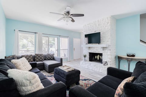 Cozy and spacious living area with TV and fireplace