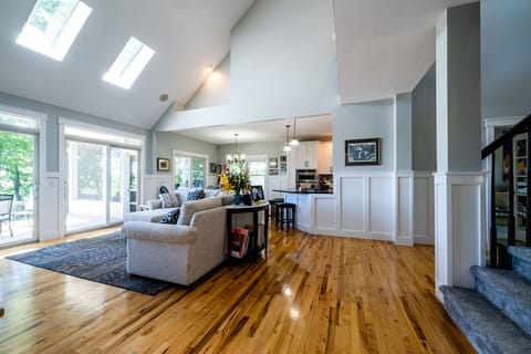 Open floor plan with living room, dining room, and kitchen overlooking beautiful views of the river